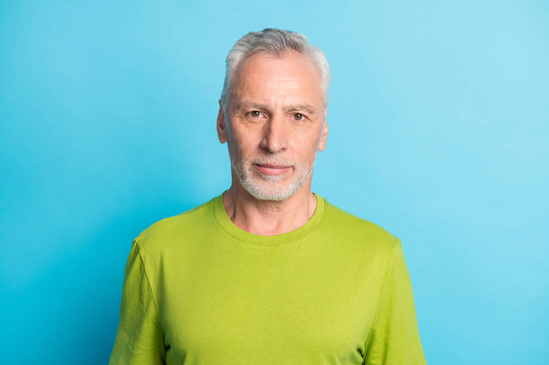 Portrait of attractive serious content bearded grey-haired guy isolated over bright blue color background - Fotografie, Obrázek