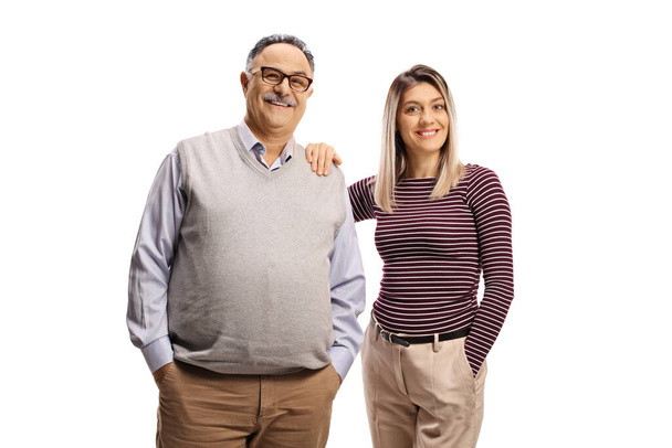 Young woman holding a mature man on his shoulder and smiling at camera isolated on white background - Photo, Image