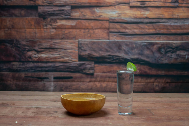 jicara with mezcal and shot of silver tequila in bar - Foto, Imagen