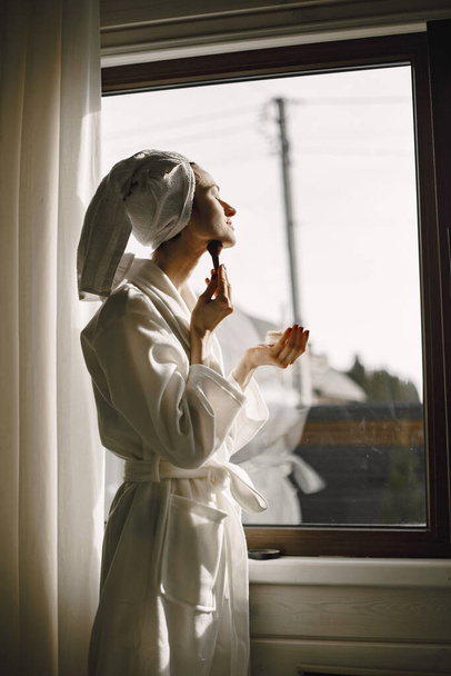 Girl in a bathrobe and towel on her head - Foto, Bild