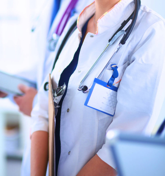 Woman doctor standing at hospital witih folder - Fotoğraf, Görsel