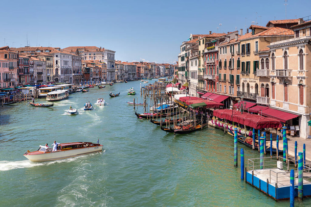 Venice, Italy, 07.04.2019: view from Rialto Bridge to Grand Canal, Riva del Vin street with colourful old houses along the canal. - Zdjęcie, obraz
