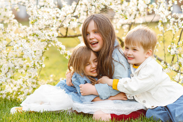 portrait of three children in the spring in nature - Zdjęcie, obraz