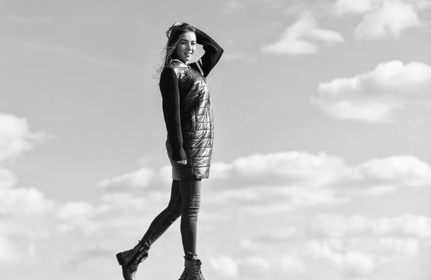 autumn and spring style. Young and beautiful woman over sky background. above the clouds. looking far away, sense of freedom. future and success. lifestyle concept. trendy girl in casual fall coat - Foto, afbeelding