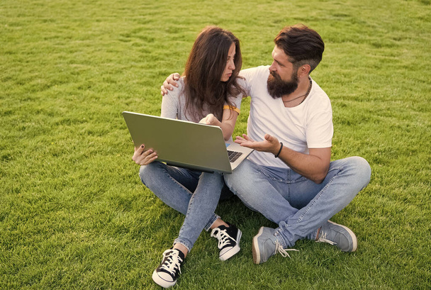 Cheerful couple watching series laptop outdoors, choose movie concept - Photo, image