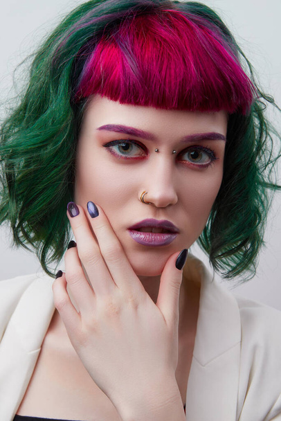 Beautiful woman with purple green professional colored hair. Bright eyes and lips makeup - Foto, Imagem