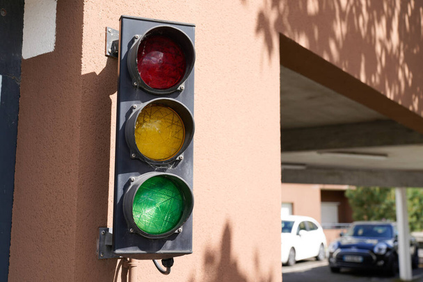 Green traffic lights to manage traffic from the car exit from the garage residential entrance - Photo, Image