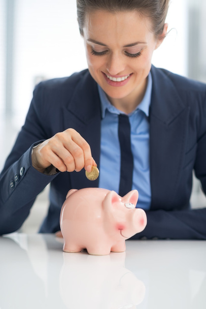 Business woman putting coin - Photo, Image
