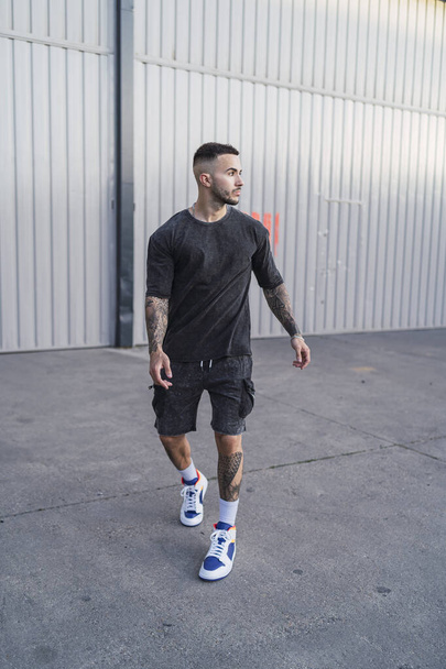 A young man with tattoos in cool casual style - 写真・画像