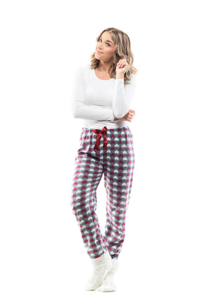 Happy cute young woman in home wear cozy pajamas looking at camera having idea.  Full body length isolated on white background. - Fotografie, Obrázek