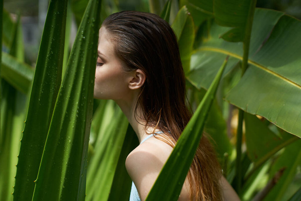 pretty woman naked shoulders green leaves jungle exotic - 写真・画像