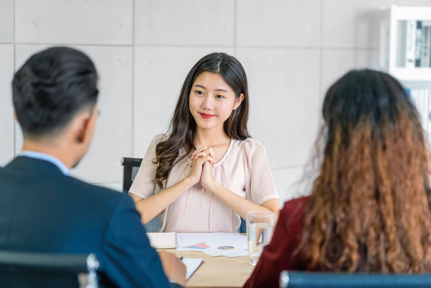 Young Asian woman graduate interviewing with two manager with positive motion in meeting room,Business Hiring new member, Job interview with manager concept - Photo, Image