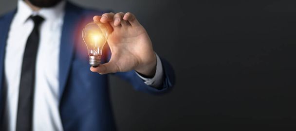 idea concept, business man holding light bul - Фото, изображение