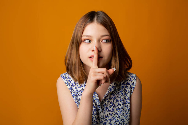 young female with hand gesture on yellow background - Fotografie, Obrázek