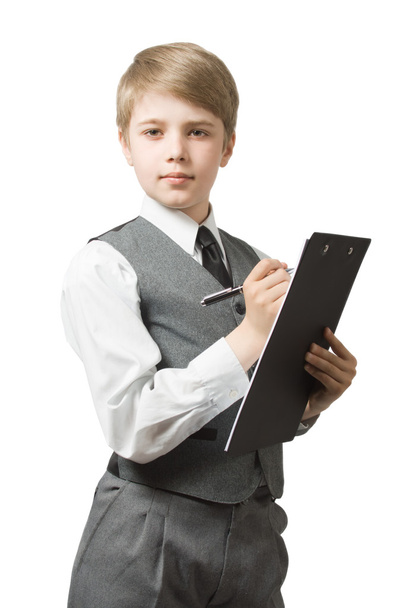 Boy in uniform suit with clipboard and pen, looking at camera. Isolated on white. - Fotografie, Obrázek