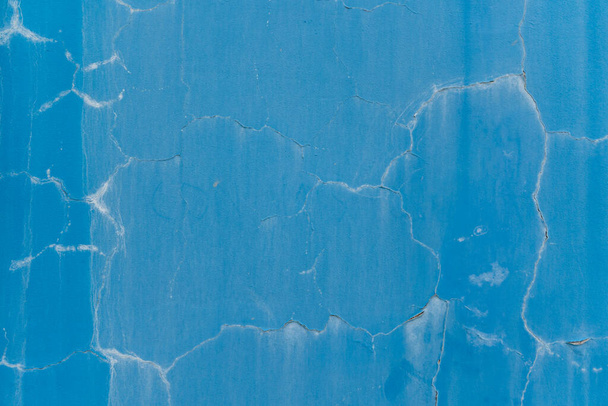 Blue wall with paint cracks and aging stains. Texture wallpaper background. - Foto, immagini