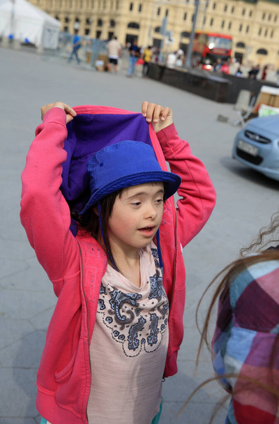 Little girl with down syndrome in the city - Photo, Image