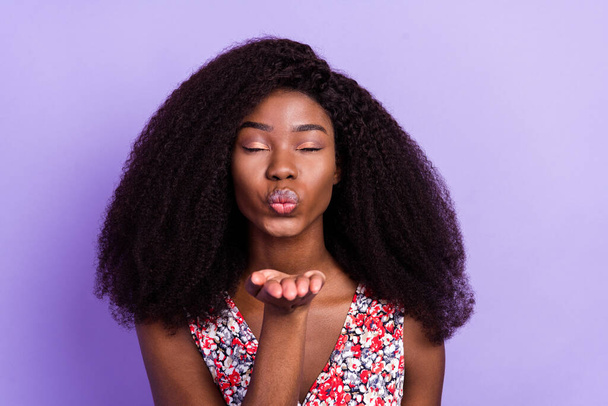 Photo of young afro girl pouted lips send air kiss you flirty romantic isolated over purple color background - Foto, Imagen