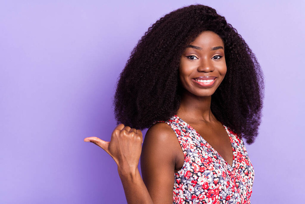 Photo of young afro girl happy smile indicate thumb empty space ad advise sale suggest isolated over violet color background - Photo, Image