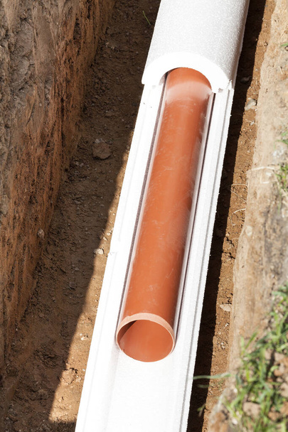 Installation of water main, sanitary sewer, storm drain systems, plastic pipes wrapped in insulation - Photo, Image