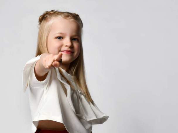 Close up of the index finger of a cute little girl pointing at you. White background. - Fotografie, Obrázek