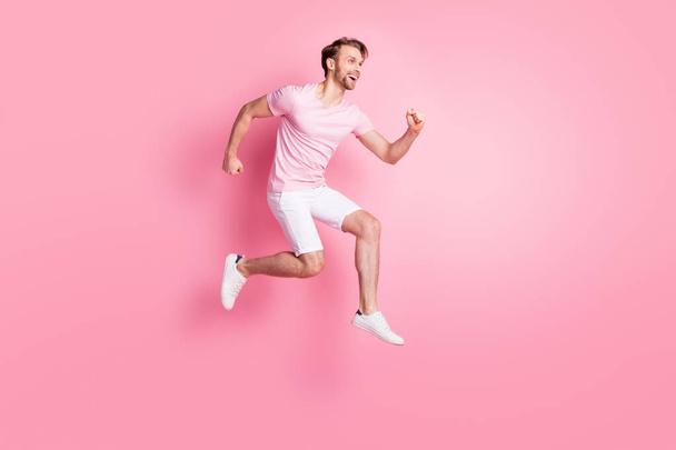 Full body profile photo of active cheerful man rush look interested empty space isolated on pink color background - Valokuva, kuva