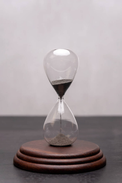 Hourglass on the stand. Urgency and outcome of time. Time management. Vertical frame. - Φωτογραφία, εικόνα