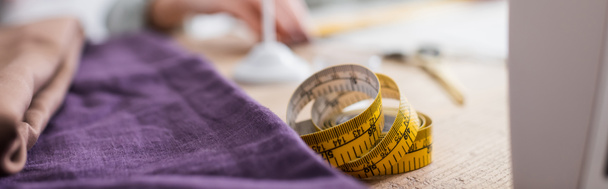 Measuring tape and cloth on table, banner  - Fotó, kép