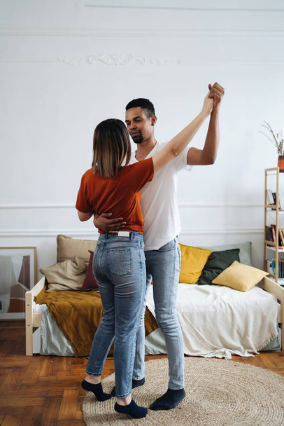 Mixed race couple dancing at home - Photo, Image