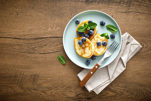 Banana pancakes with fresh blueberry, top view - Photo, image