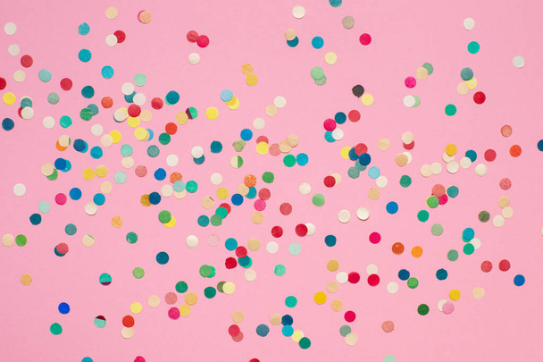 multicolored paper confetti on pink isolated background - Zdjęcie, obraz