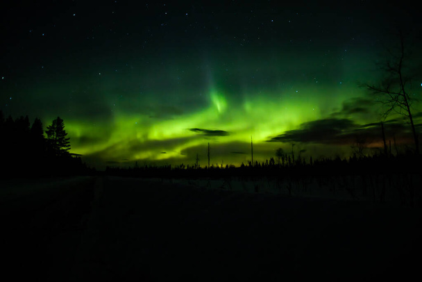 Northern lights and clouds in northern Sweden. - Foto, Imagem