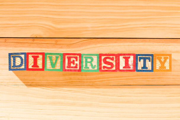 Spectacular wooden cubes with the word DIVERSITY on a wooden surface. - Photo, Image