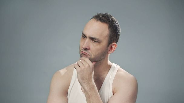 Photo of thinking bristly man on gray background - Photo, Image