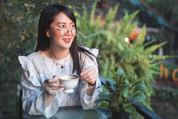 Happy of asian people business female hold a coffee cup mug casual Relaxed in the morning in coffee shop,Business Lifestyle concept - Foto, immagini