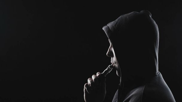 Photo of man with the vape in hood - Foto, imagen