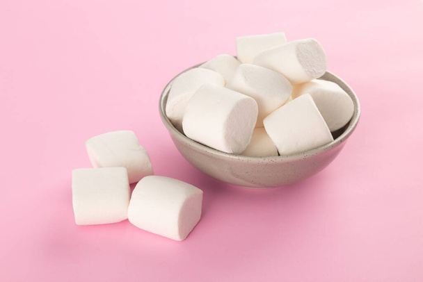 Marshmallow in bowl on pastel pink background. - 写真・画像
