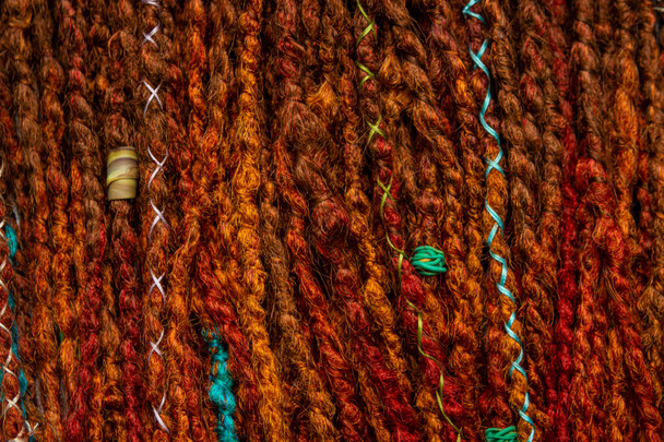 Braided colored pigtails as a background. Bright braided braids. Handmade - Valokuva, kuva
