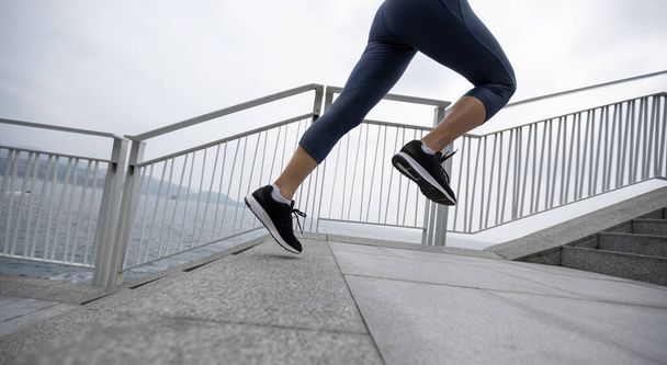 Healthy lifestyle fitness sports woman runner running on seaside trail - Foto, Bild