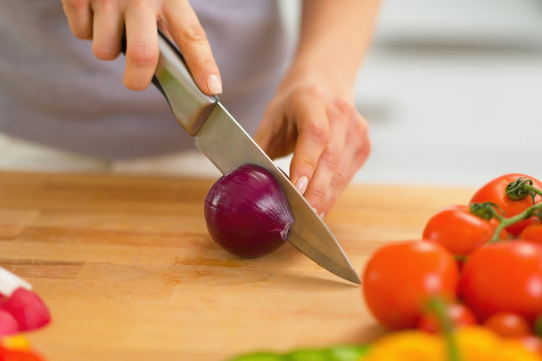 Closeup on young woman cutting onion - Zdjęcie, obraz