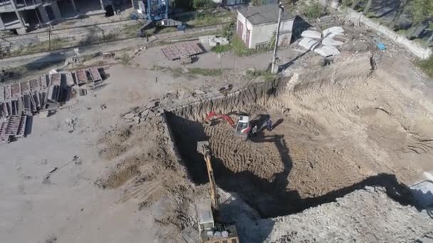 Aerial of a building's foundation and a tower crane - Filmati, video