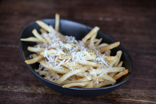 Close up of French Fries with cheese in a cup - Fotó, kép