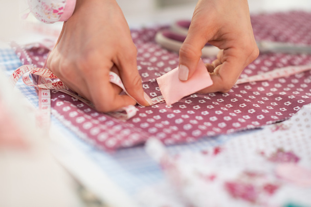 Seamstress making marks on fabric - Фото, зображення