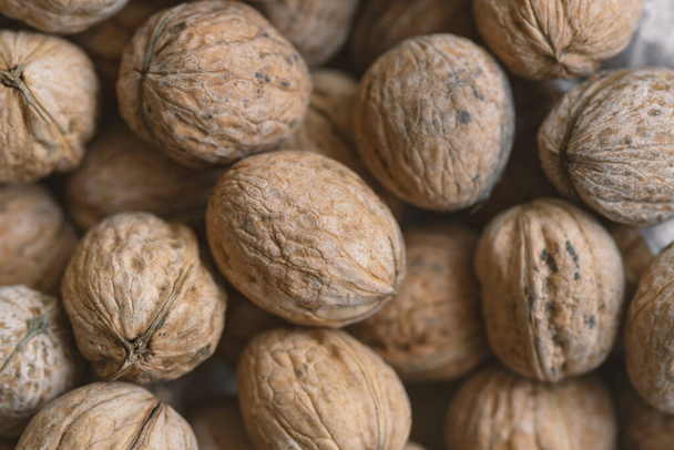 Lot of  walnuts in the pile.Background of fresh walnuts. - Photo, image