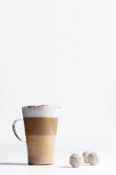 Milk coffee or latte macchiato glass, on white background. Italian coffee with milk and layers. Gourmet coffee. - 写真・画像