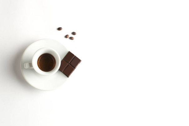 Cup of coffee with chocolate  on white background. Cup of espresso.Top view - Фото, изображение