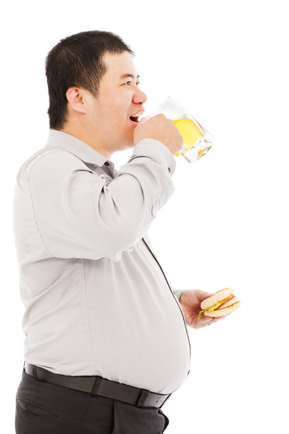 gros homme d'affaires boire une tasse de bière et manger un hamburger
 - Photo, image
