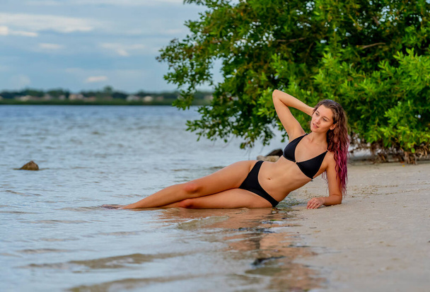 Piękna brunetka model bikini cieszy się pogodą na zewnątrz na plaży - Zdjęcie, obraz