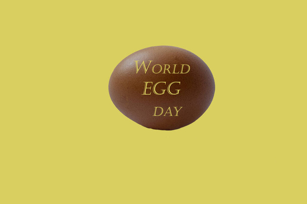 Egg on yellow background, for the world egg day. National Egg Day on June 3 . Copy space - Photo, Image