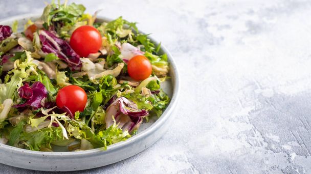 Healthy salad with mix  fresh lettuce and tomatoes. Diet food concept. Copy space  - Photo, image